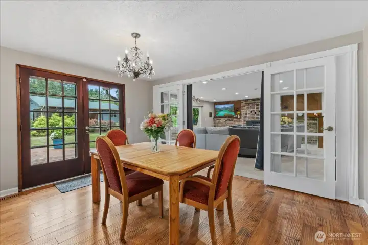 Elegant dining space with French doors leading to the deck and yard, seamlessly connected to the living area for easy gatherings. Elegant dining space with French doors leading to the deck and yard, seamlessly connected to the living area for easy gatherings.