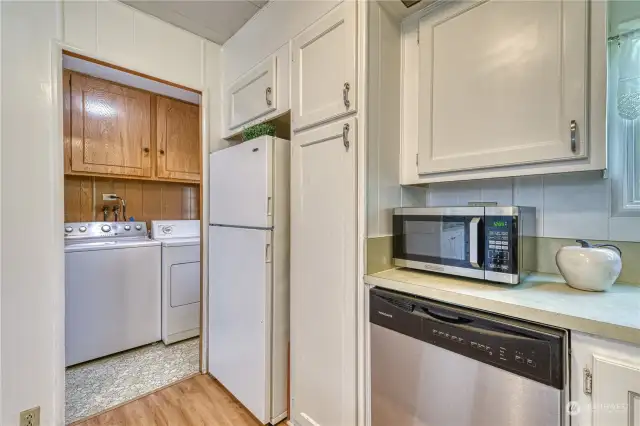 Kitchen towards laundry room and backdoor accessing back/side yards