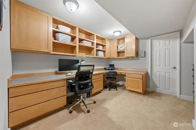 The built-in home office provides an organized workspace with extensive cabinetry and ample storage. Its thoughtful design makes it ideal for working remotely or managing daily tasks. The door to the right leads you to the mechanical room.