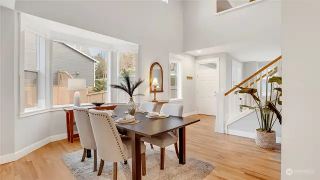 Formal dining room with high vaulted ceilings and gleaming wood floors