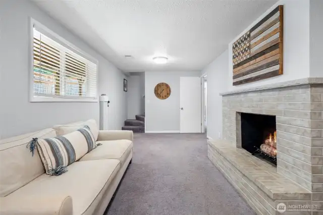 Lower-level family room with fireplace.