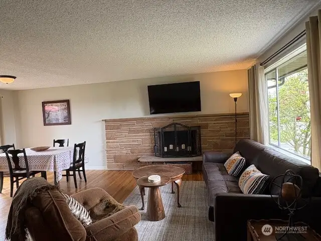 Welcome to the cozy living room with wood burning fireplace
