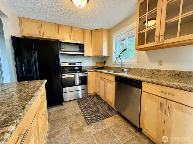 Updated Kitchen with shaker cabinets, stone counters and large sink.  New appliances.