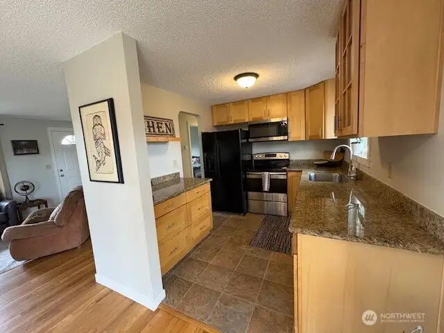 Walk through kitchen, large country sink and stainless appliances