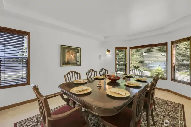 Living room with bay window currently being used as dining room to accommodate seating for up to twelve. Seller willing to leave table with two leaves and ten chairs.