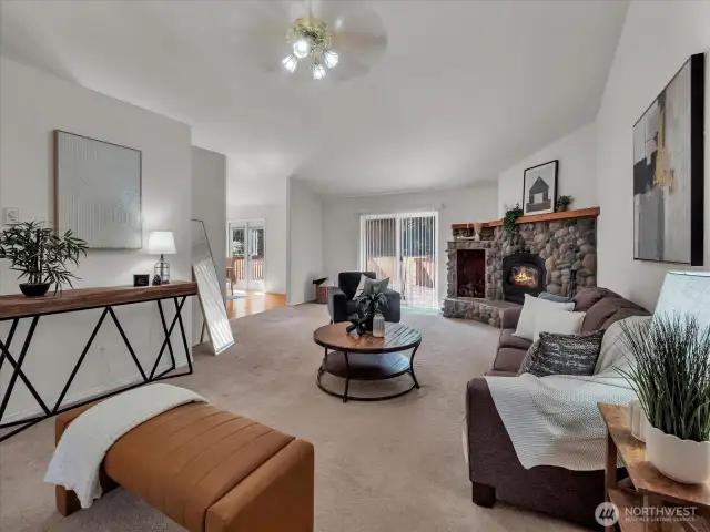Living room next to kitchen and dining room and leading to large deck.