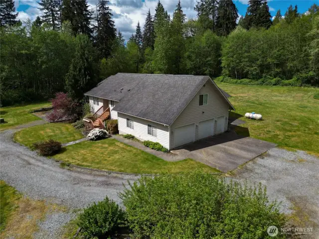 Garage faces circular driveway.