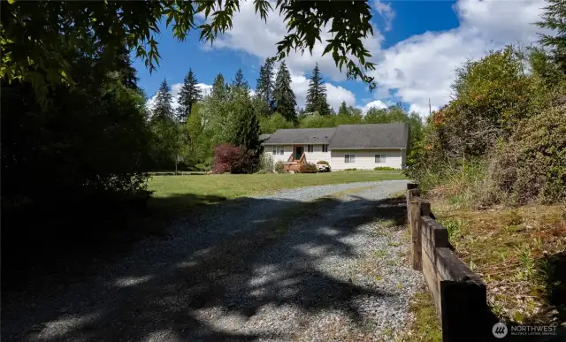 The home is set off the road with a long driveway for ultimate privacy.