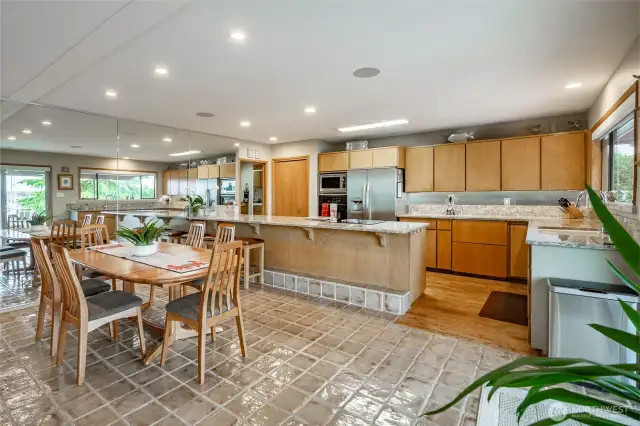Spacious kitchen area with mirrored wall for exceptional views no matter which way you look. Dining area table expands with multiple leafs. Nice lightinig.