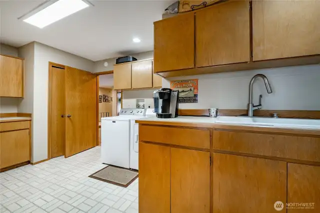 Utility with with backdoor down to the garage. Lots of cabinet space in here for pantry and desk if wanted.