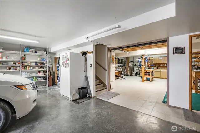 A view from the garage with interior roll up garage door into the workshop.