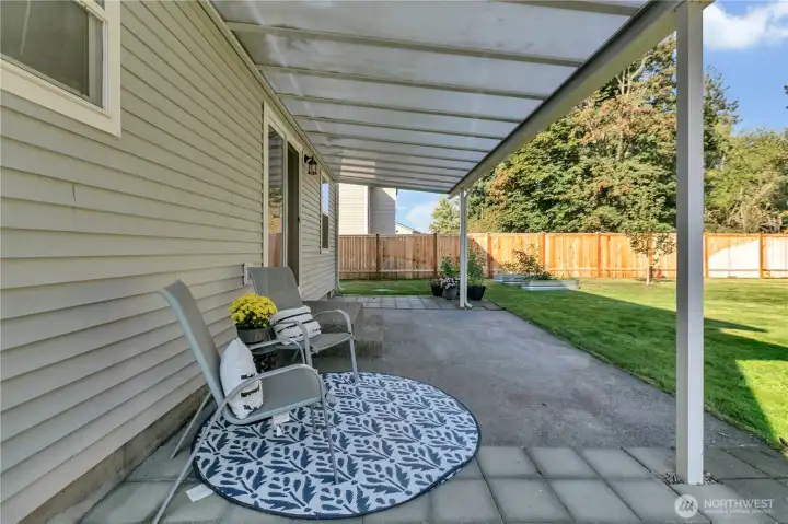 Enjoy outdoor living rain or shine under the covered back patio—perfect for relaxing or hosting guests.