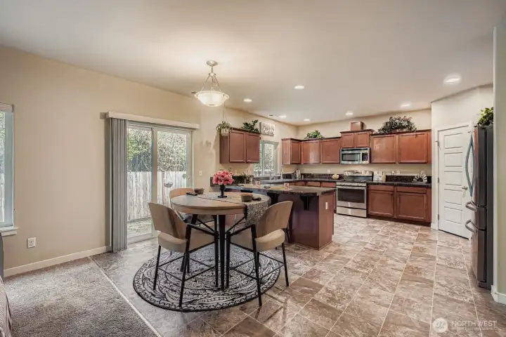Great room concept combines kitchen, informal dining & living room to provide a welcoming environment for family & friends. The sliding glass door pictured here leads to your patio & hot tub (which stays!)