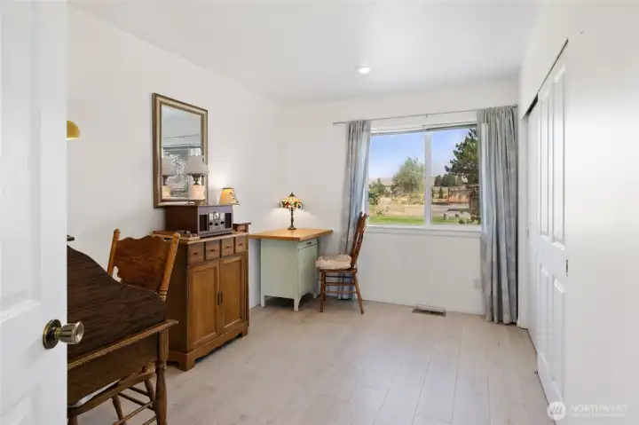 2nd bedroom with laminate flooring and great view into front yard.