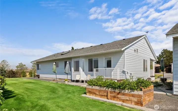 Back of the home and garden bed. Beautiful mature landscaping all around the property too.
