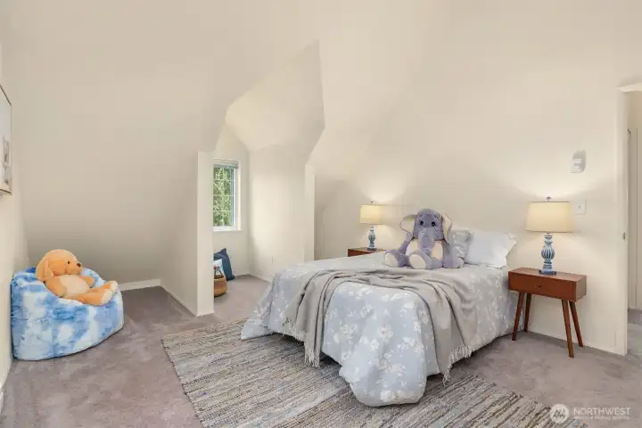 one of the two upstairs bedrooms. Note the sweet window overlooking the lush yard.