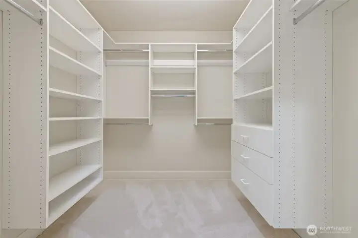 Large walk-in closet between primary bedroom and primary bath
