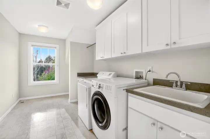 Large laundry room with storage space and natural light from window
