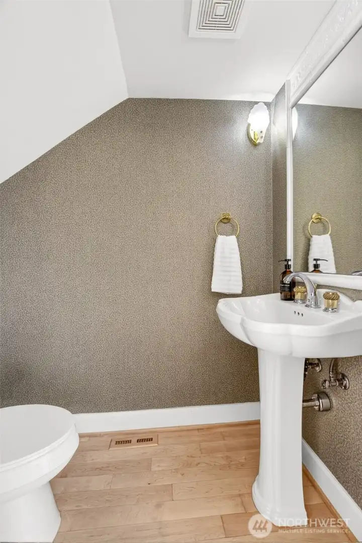 Powder room/ half bath tucked under the main stairs on the main floor