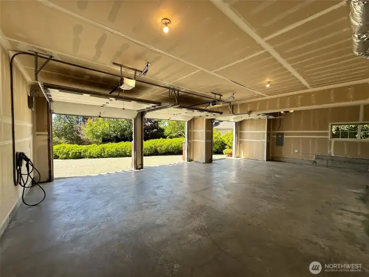 large 3 - 4 car garage (4th stall is tandem in the back) with plenty of storage with optional 4th tandem stall and EV charger included