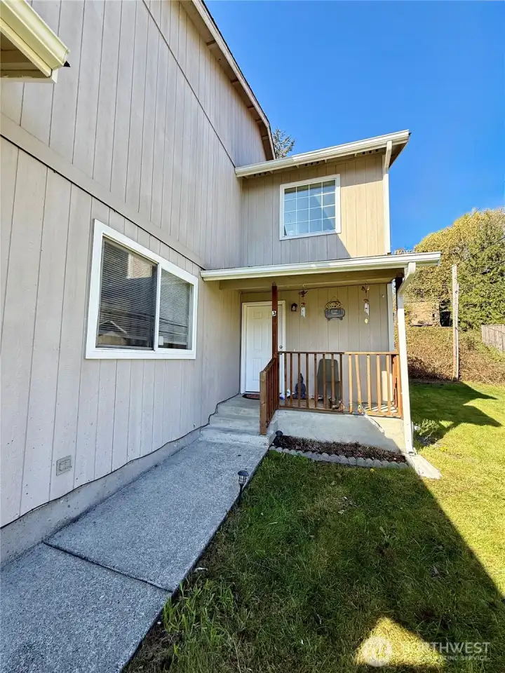 Each unit has a small covered porch leading into the front door.