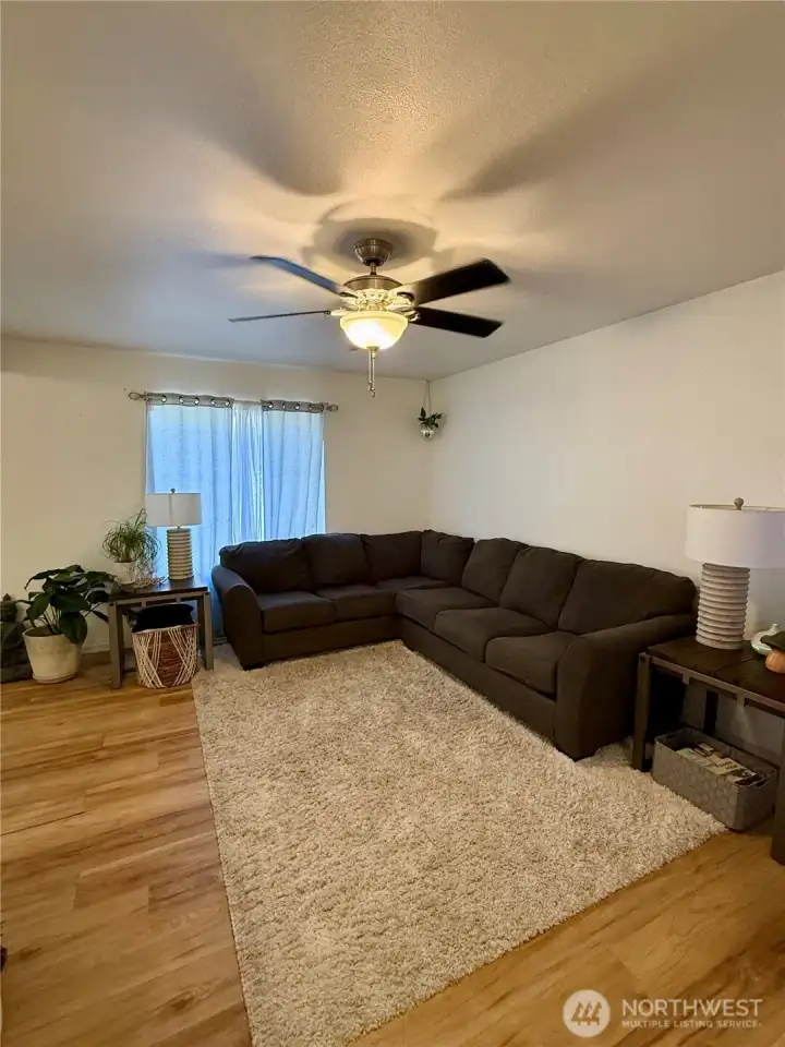 Large living room, with sliding glass door leading to fenced in back yard and covered porch.