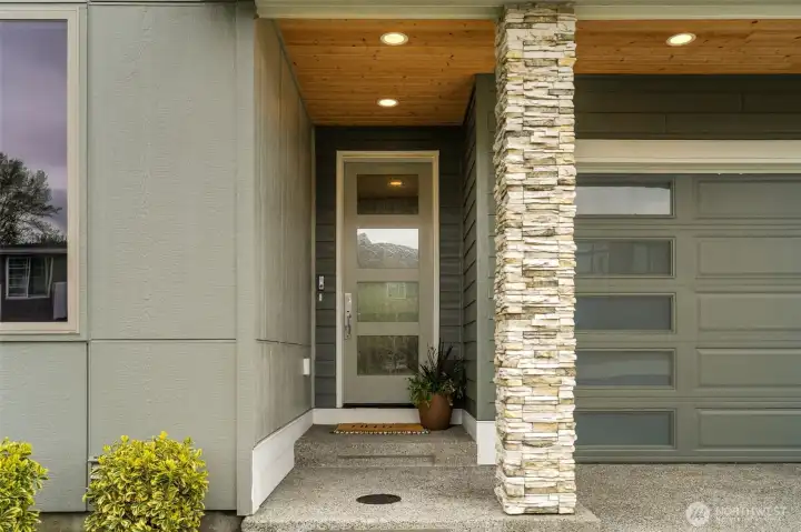 Grand entry highlighted by pine soffit, masonry and 8ft glass door.