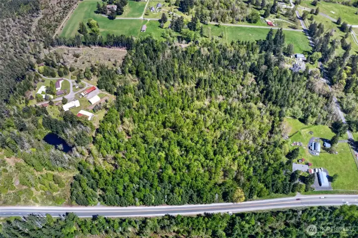 These combined parcels are filled with stunning evergreens and attract abundant wildlife, including elk and deer. The property also benefits from excellent exposure along Mountain Highway.