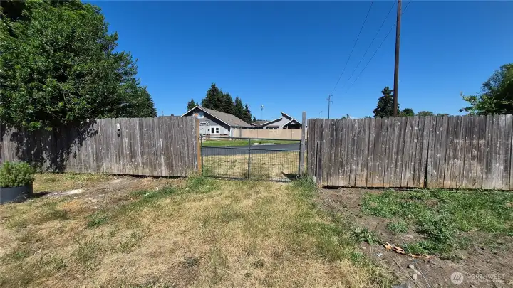 Gate access from another street to large, fenced back yard.