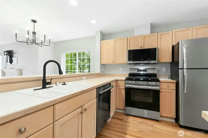 Kitchen featuring stainless steel appliances, abundant cabinet and counter space, and breakfast bar seating. Kitchen featuring stainless steel appliances, abundant cabinet and counter space, and breakfast bar seating.