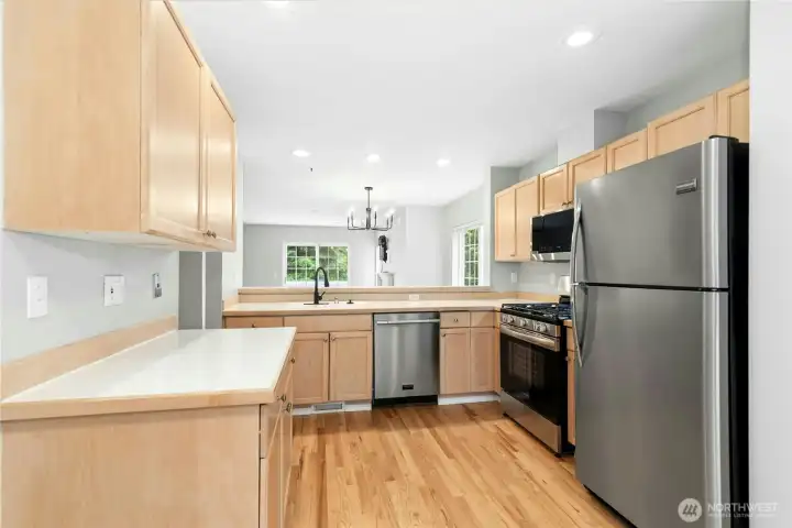 Functional kitchen with stainless steel appliances, generous workspace, and an open layout. Functional kitchen with stainless steel appliances, generous workspace, and an open layout.