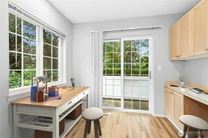 Virtually Staged - Bright breakfast nook shown as a crafting and hobby space with views of the rear deck and surrounding trees. Virtually Staged - Bright breakfast nook shown as a crafting and hobby space with views of the rear deck and surrounding trees.