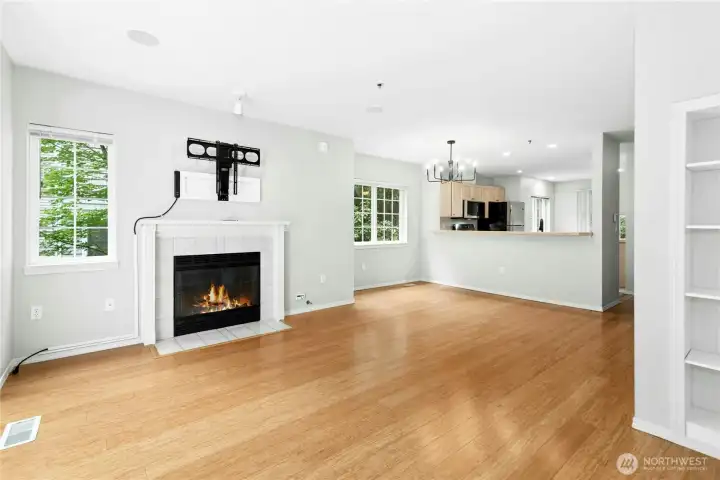 Open living room with vaulted ceilings, gas fireplace, and abundant natural light. Open living room with vaulted ceilings, gas fireplace, and abundant natural light.