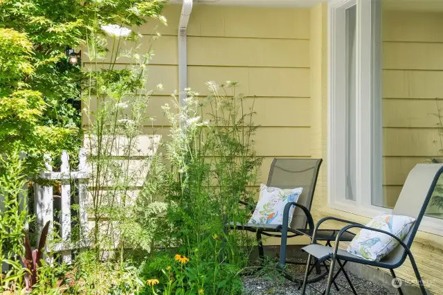 West-facing front and perennials provide a sunny seating area in front of the large living room windows.