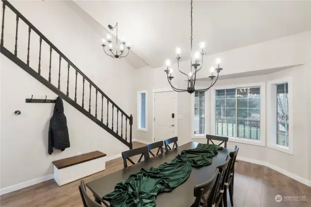 New modern light fixtures, painted dramatic black staircase and note the wood trimmed windows