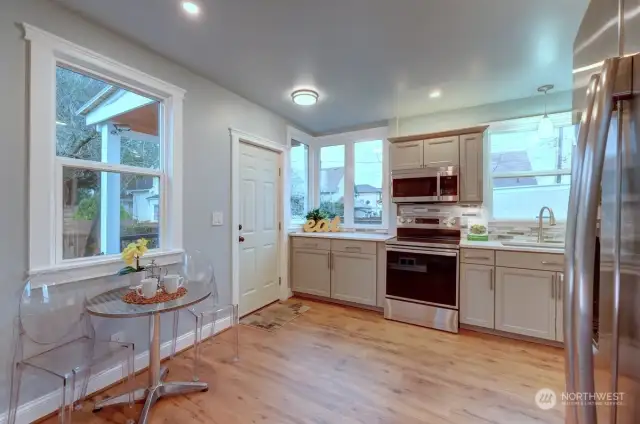 Kitchen with Eating Space & Back Door To The Fenced Yard.