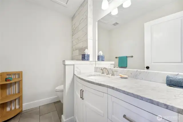 The main floor bedroom has its own half bathroom.
