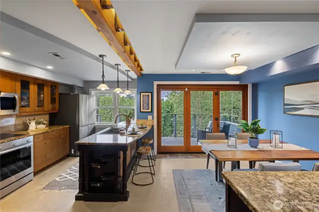 This kitchen is for every chef.  Gas range, beautiful island with seating, granite countertops, under cabinet lighting.  Nana door opens to first deck.
