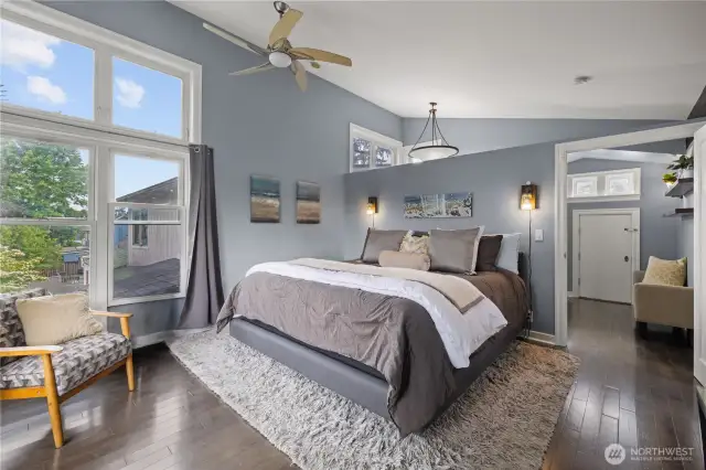 Vaulted ceiling in the spacious primary bedroom.  Huge windows, updated flooring.