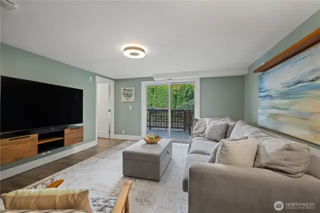 Family Room opens to another covered deck with steps to garden and back yard.  Half bath.