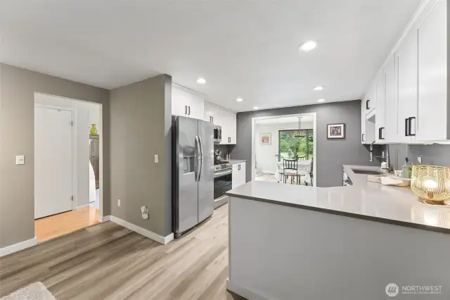 The kitchen is new, with LVP flooring, slate counter tops and plenty of storage space in the cabinets.