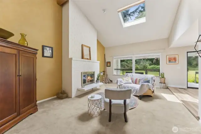 The sunkenliving room, soaring ceiling with skylights and the massive fireplace is a nod to mid-centry modern style.