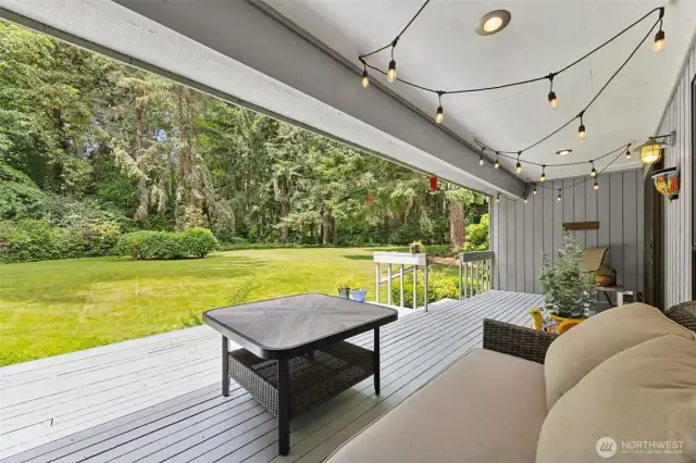 Before leaving the main floor, let's step outside onto the covered deck. The wooded area has a trail leading you throuhg the lush surroundings...like hiking through the rainforest.