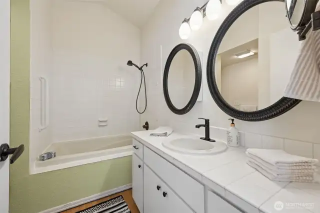 The primary bathroom has a tub/shower combination, and a step in shower to the left.