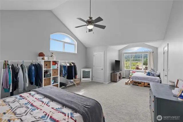 The bonus room is being used as an additional bedroom. This spacious room offers vaulted ceilings, large windows, closets space and is the 3rd area in this home that offers ample room for gathers or relaxing (home offers a down stairs living room and family room and this upstaris bonus room).