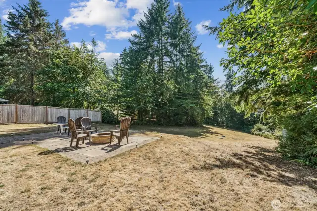 Expansive lawn and back yard with fun firepit for smores!