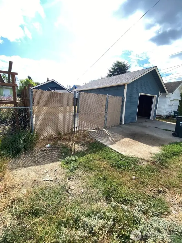 Ally view to garage area with extra parking and drivein entrance to back.