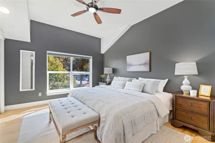 Big enough for a king (and more), this bedroom layers comfort with style: moody dark grey walls, a sleek ceiling fan, and double closets with built-in lights. Direct access to the modern ¾ bath adds convenience, while the vibe is all about cozy sophistication—your own  private escape at the end of the day.