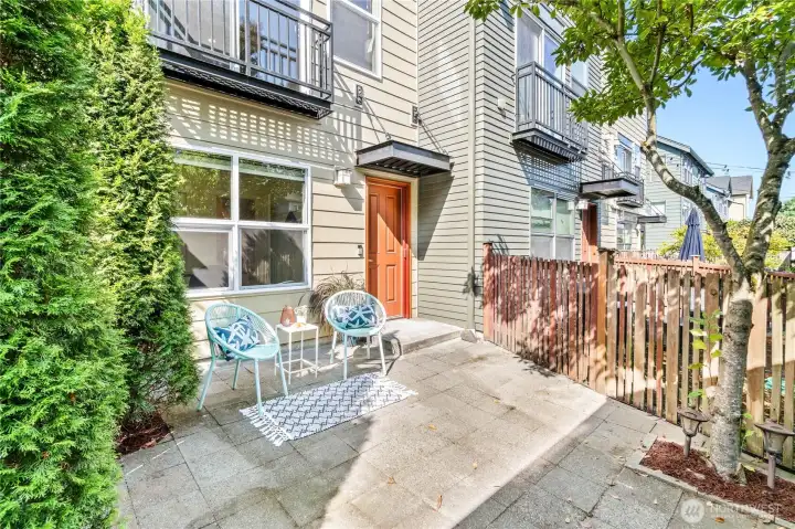 Step out from the lower level to a fully fenced backyard patio—with plenty of space for lounging & grilling.  Tall trees add privacy, while a water spigot, electrical outlet and direct access to the garage.