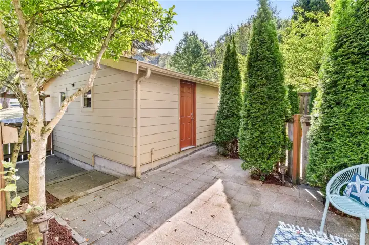 Step out from the lower level to a fully fenced backyard patio—with plenty of space for lounging & grilling.  Tall trees add privacy, while a water spigot, electrical outlet and direct access to the garage (one of the only homes in Rainier Vista w/a man-door) provide convenience. Speaking of convenience - that alley out back means no dragging garbage bins around front on pick-up day (Fridays, by the way)!